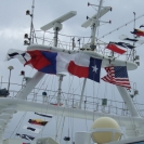 Some flags flying in the radar masts