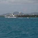 A large yacht passing in front of a large radar dish