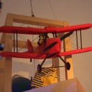 A Lego biplane flying over a Lego Sphynx