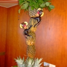 A fruit and vegetable carving of monkeys climbing a palm tree