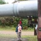 Cathy reaching up to touch the pipeline