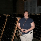 Cathy in front of the sparkling wine bottles